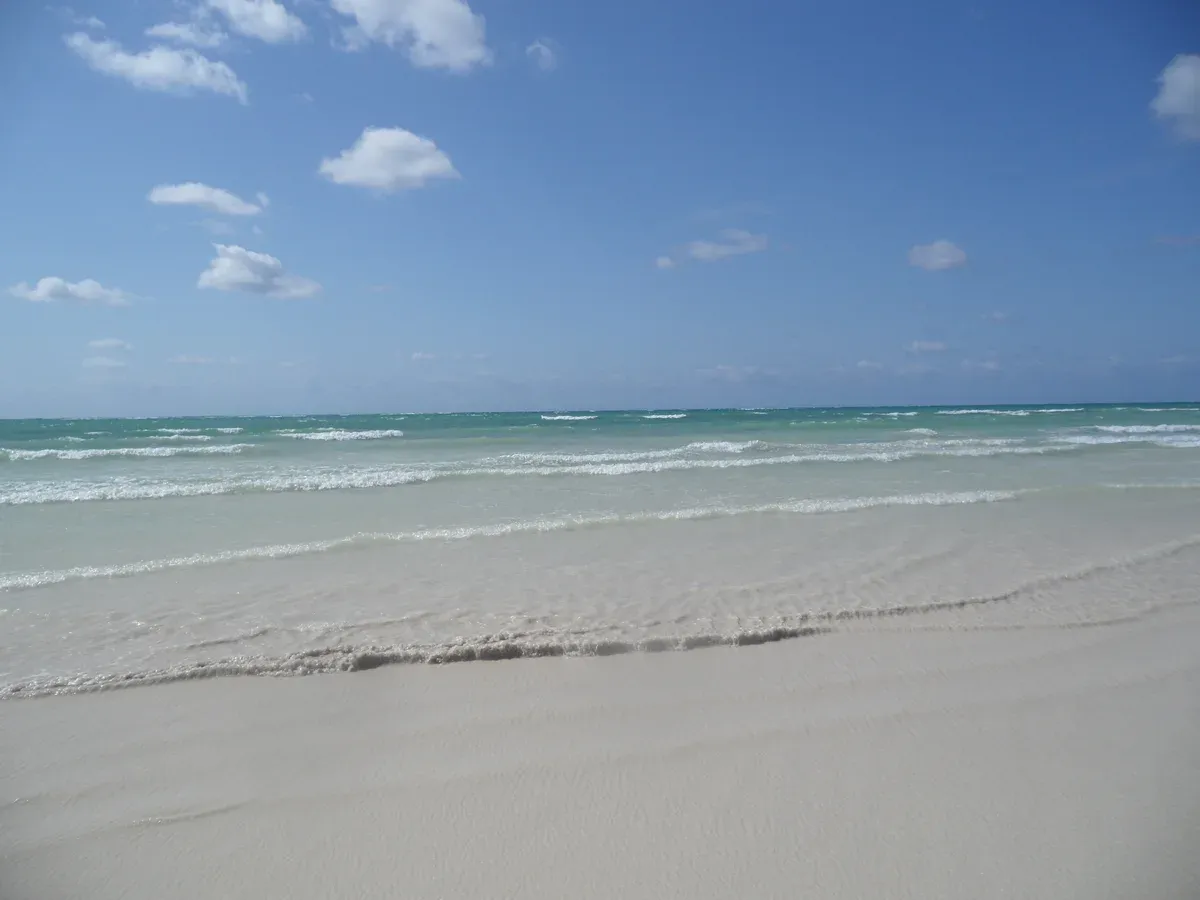 Empty sand beach and clear surf on Grand Bahama near Freeport, close to Paradise Cove Freeport